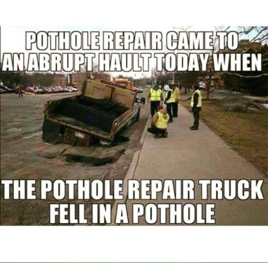 Funny meme of a pothole repair truck that fell into a pothole, with workers standing around. Text reads: "Pothole repair came to a halt."