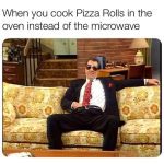 Man relaxing on a couch after cooking pizza rolls in the oven.