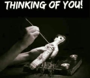 Hand holding a voodoo doll with needles, captioned 'Thinking of You.'