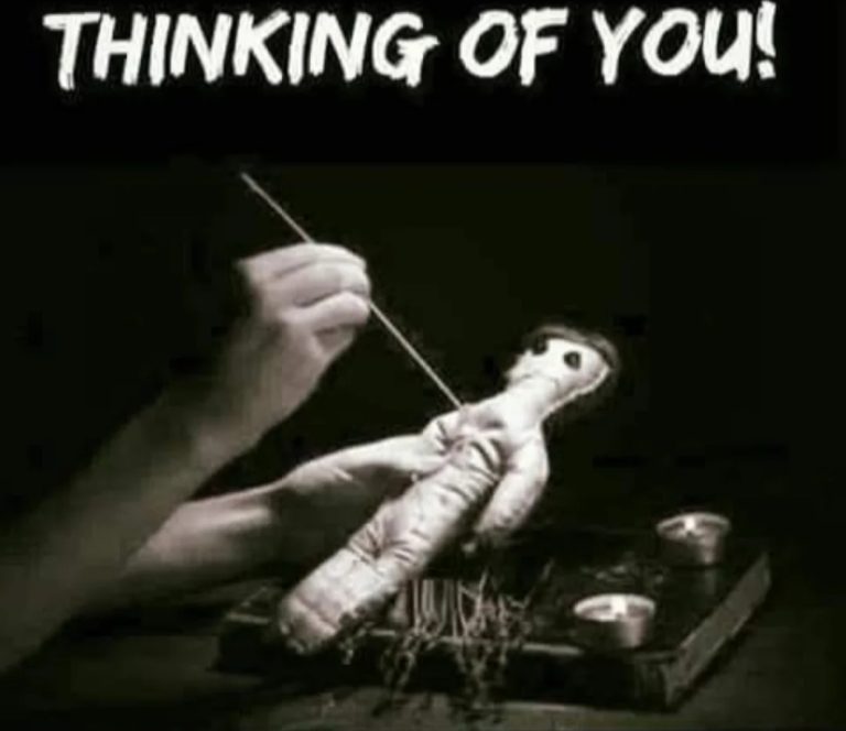Hand holding a voodoo doll with needles, captioned 'Thinking of You.'