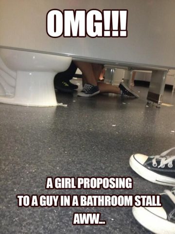 A humorous scene of a girl kneeling in a bathroom stall, resembling a proposal.