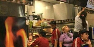 A McDonald's screen hack displaying inappropriate content due to unchanged default passwords.