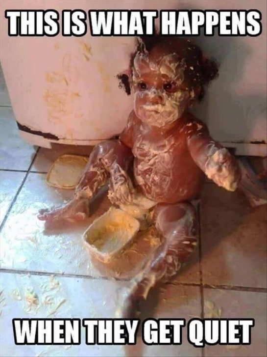 Baby covered in food making a mess on the floor