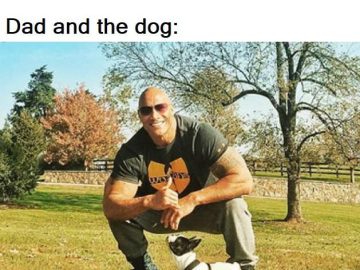 A man kneeling with a smiling expression, next to a small dog in a park.