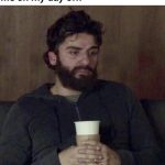 Tired man on sofa holding cup, reflecting day off meme humor.