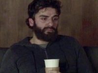 Tired man on sofa holding cup, reflecting day off meme humor.