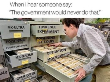 Person examining file cabinet labeled with government conspiracy projects.