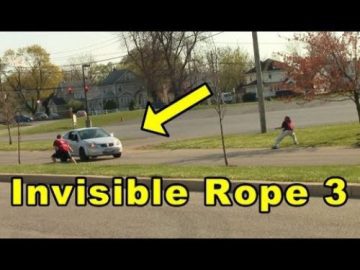 People pretend to hold an invisible rope across the road.
