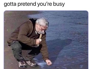 Man pretending to hammer nails into the beach