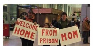 Family holds humorous welcome sign at airport