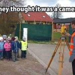 Group of kids posing in front of a survey tool thinking it's a camera.