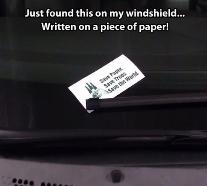 Ironic paper note on windshield saying, Save paper