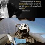 Fighter pilot in cockpit reading "So You Want to Be a Pilot" book.