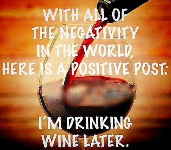Glass of red wine with text about drinking wine as positivity.