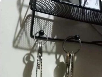 Key shadows create a hanging figure in a dark humor twist.
