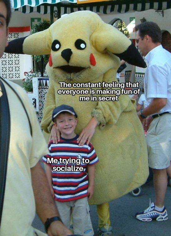 Boy posing with awkward mascot, captioned about social anxiety.