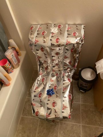 Toilet humor taken literally with a fully gift-wrapped toilet.