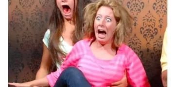 Two shocked women reacting dramatically to a flipped pillow joke.