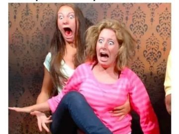 Two shocked women reacting dramatically to a flipped pillow joke.
