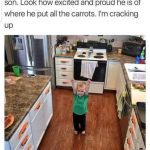 Little boy proudly showing off his organized carrot handles in the kitchen.