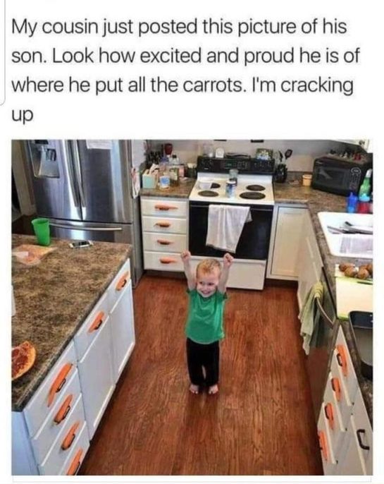Little boy proudly showing off his organized carrot handles in the kitchen.
