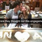 Couple kisses in front of funny engagement rice message mistake.