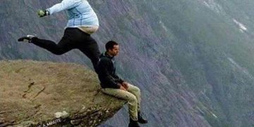 Person being caught off guard on a cliff, symbolizing Monday's sudden arrival.