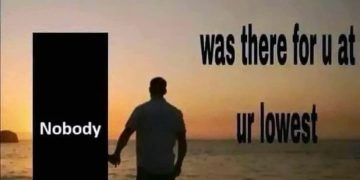 Man walks with "Nobody" at sunset, highlighting isolation.