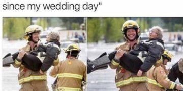 Firefighter carrying a smiling grandma through water, joyful moment.