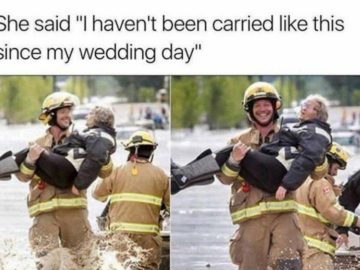 Firefighter carrying a smiling grandma through water, joyful moment.