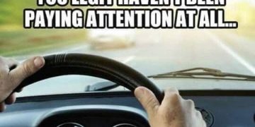 Hands on steering wheel with humorous text about not paying attention while driving.
