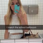 Woman in white outfit blending into school bathroom tiles mirror selfie