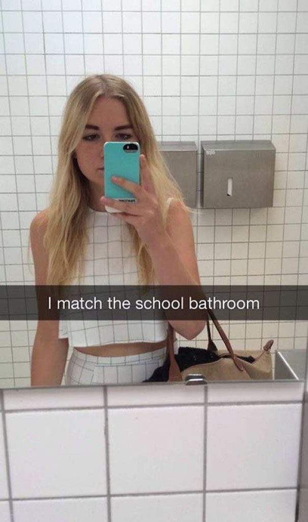 Woman in white outfit blending into school bathroom tiles mirror selfie