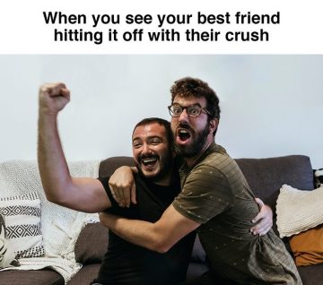 Two friends celebrating on a couch as one hits it off with their crush.