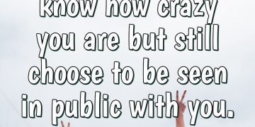 Two best friends having fun, arms raised, celebrating friendship.