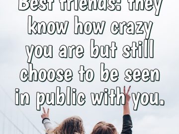 Two best friends having fun, arms raised, celebrating friendship.