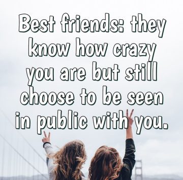 Two best friends having fun, arms raised, celebrating friendship.