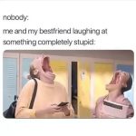 Two friends laughing hysterically in a school hallway