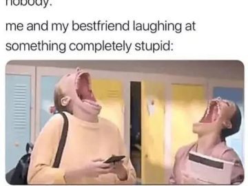 Two friends laughing hysterically in a school hallway