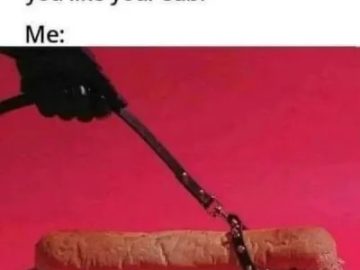 A sub sandwich humorously strapped with a belt on pink background.