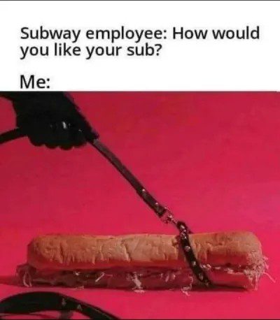 A sub sandwich humorously strapped with a belt on pink background.