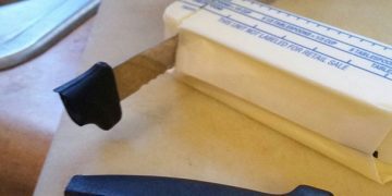 Broken knife stuck in butter with caption "I guess I should've used a butter knife."