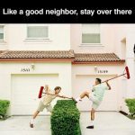 Two neighbors using brooms to keep each other away.