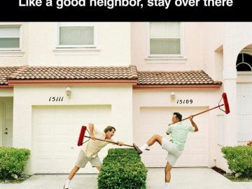 Two neighbors using brooms to keep each other away.