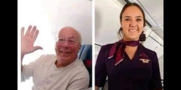 Dad smiles on plane next to flight attendant daughter during Christmas.