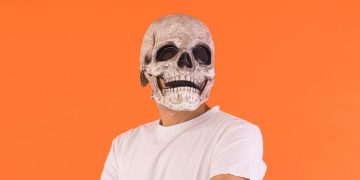 Person wearing a skull mask with a humorous caption about being dead inside.