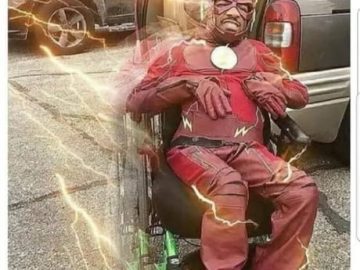 Man in superhero costume with humorous overlay about camera flash.