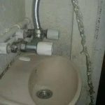 Hilarious DIY plumbing fail with a faucet missing the sink entirely.