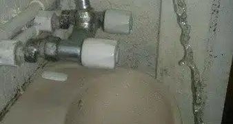 Hilarious DIY plumbing fail with a faucet missing the sink entirely.