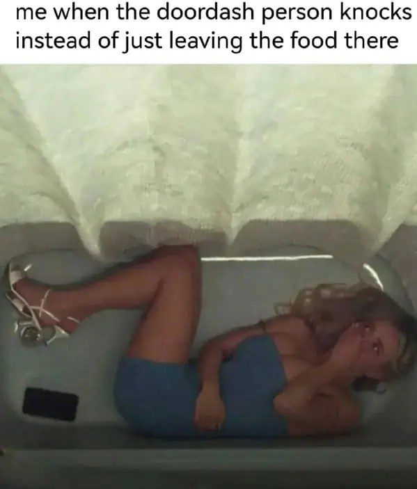 Person hiding in a bathtub due to DoorDash delivery anxiety.